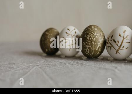 Easter holiday. Painted olive-colored eggs on a linen tablecloth. Easter decoration. Stock Photo