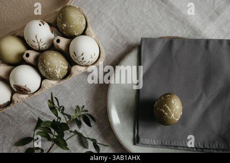 Easter holiday. Painted olive-colored eggs on a linen tablecloth. Easter decoration. Stock Photo