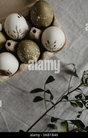 Easter holiday. Painted olive-colored eggs on a linen tablecloth. Easter decoration. Stock Photo
