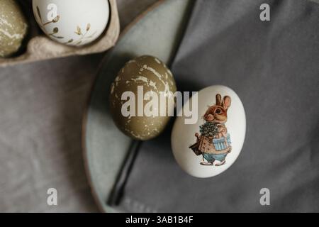 Easter holiday. Painted olive-colored eggs on a linen tablecloth. Easter decoration. Stock Photo