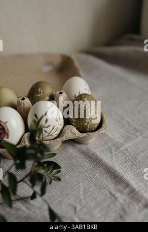 Easter holiday. Painted olive-colored eggs on a linen tablecloth. Easter decoration. Stock Photo