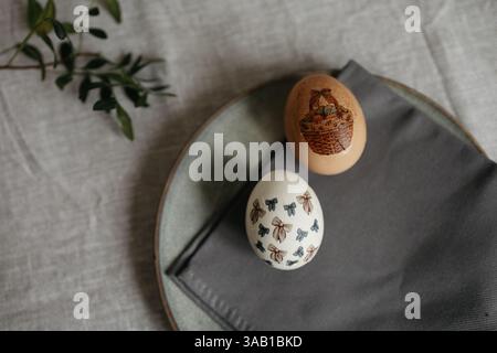 Easter holiday. Painted olive-colored eggs on a linen tablecloth. Easter decoration. Stock Photo