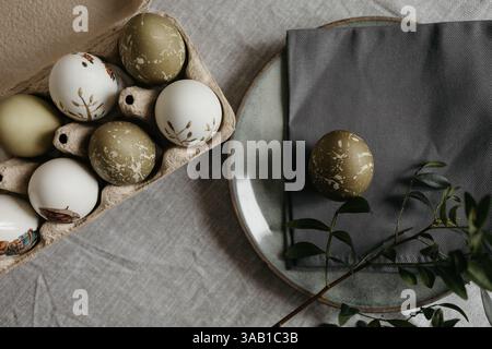Easter holiday. Painted olive-colored eggs on a linen tablecloth. Easter decoration. Stock Photo