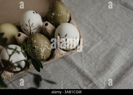 Easter holiday. Painted olive-colored eggs on a linen tablecloth. Easter decoration. Stock Photo