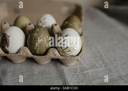 Easter holiday. Painted olive-colored eggs on a linen tablecloth. Easter decoration. Stock Photo