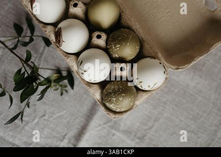 Easter holiday. Painted olive-colored eggs on a linen tablecloth. Easter decoration. Stock Photo