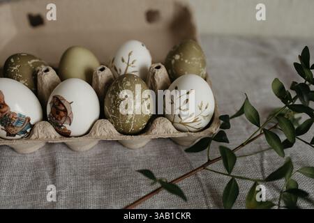 Easter holiday. Painted olive-colored eggs on a linen tablecloth. Easter decoration. Stock Photo