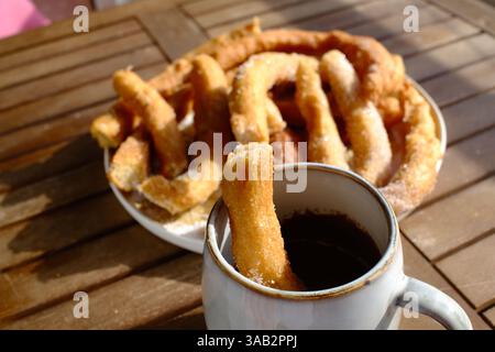 Crispy churros with hot melted chocolate for dipping Stock Photo
