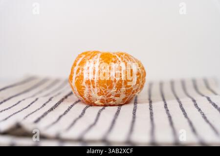 Pattern of whole tangerines or mandarin orange fruits and peeled segments isolated on white background. Stock Photo