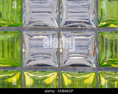 Close-up of a glass block wall with alternating green and clear blocks. Stock Photo