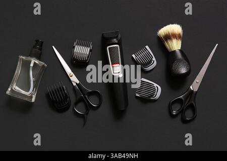 Electric trimmer and shaving accessories on black background Stock Photo