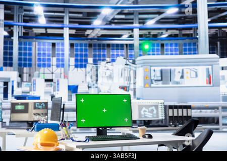 Green screen PC display used to adjust photovoltaics factory system parameters. Chroma key mockup computer monitor used for optimizing energy supply in solar panel manufacturing plant Stock Photo
