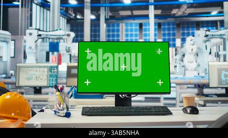 Chroma key PC in empty solar panel manufacturing plant used for developing new solar energy systems prototypes. Green screen computer monitor used for researching new photovoltaics materials Stock Photo