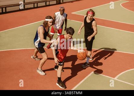 Multiracial basketballers participating in outdoor championship at court, above view Stock Photo
