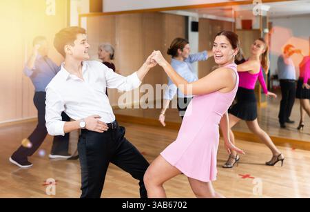Young pair practicing Latino dance in dance studio Stock Photo