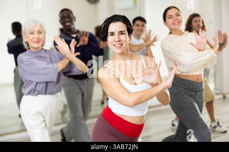 Young Hispanic woman practicing vigorous dance movements Stock Photo