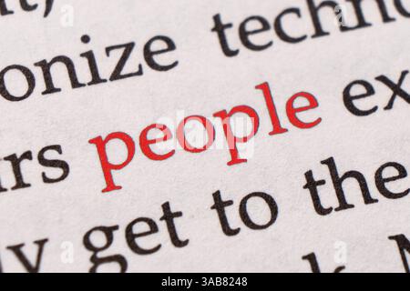 Focus on the red word People. Macro shot printed red colour word People on a piece of paper or book Stock Photo