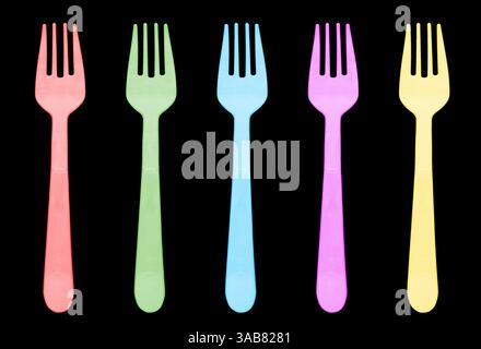 Multi color plastic fork isolated on black background. Disposable tableware set isolated Stock Photo