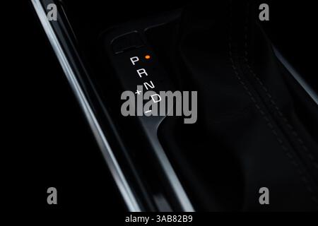 Automatic transmission shift selector in the modern car black leather interior. Selector automatic transmission in premium car. Gear shift lever. Auto Stock Photo