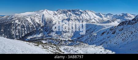 Majestic balkan mountains panoramic view. Rocky peaks ridge covered with snow in Bulgaria Stock Photo