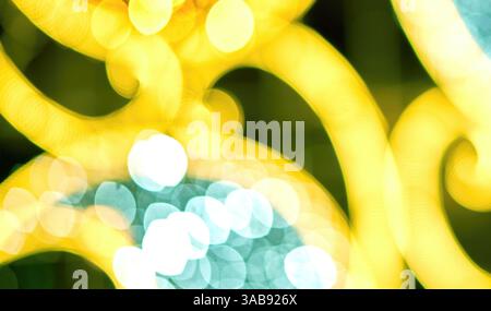 Swirling colors and shimmering lights blend together, creating an abstract background that captivates the viewer. The glowing hues shift and dance, ev Stock Photo