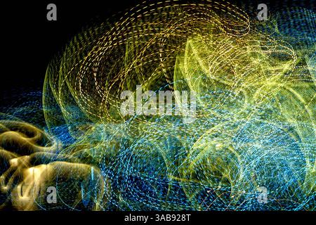 Vibrant light trails swirl and dance across the dark backdrop, creating an engaging abstract representation of movement and energy that captivates the Stock Photo