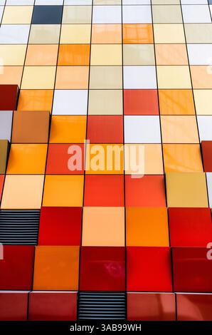 Close-up view of a vibrant and multi-colored tiled facade of a building in Hong Kong. The image showcases a spectrum of colors arranged neatly in squa Stock Photo