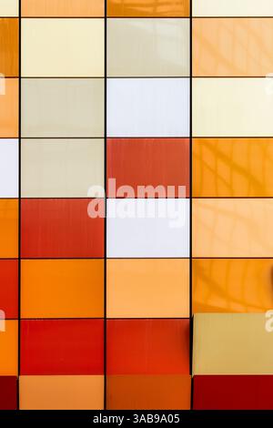 Close-up view of a vibrant and multi-colored tiled facade of a building in Hong Kong. The image showcases a spectrum of colors arranged neatly in squa Stock Photo
