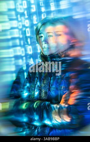 An elderly Asian woman interacts with virtual reality, surrounded by digital graphics and binary code, symbolizing the fusion of age and technology in Stock Photo