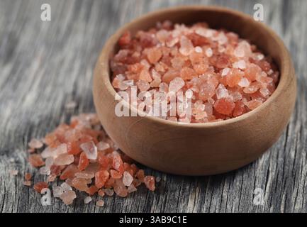 Himalayan pink salt  on wooden surface Stock Photo