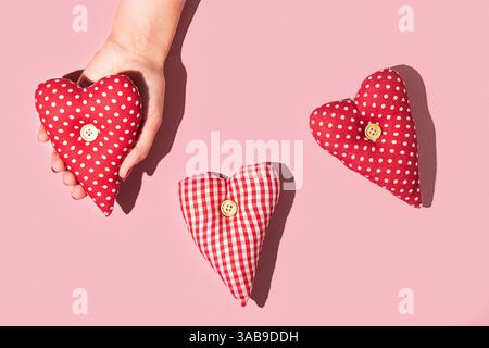 A conceptual image portraying friendship and affection, using red hearts as a universal symbol of positive emotions. The soft lighting and simple comp Stock Photo