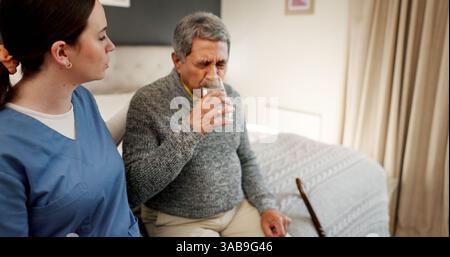 Drinking water, senior man and caregiver in nursing home, help and thirsty in bedroom and hydration. Healthcare, nurse and old person with liquid for Stock Photo