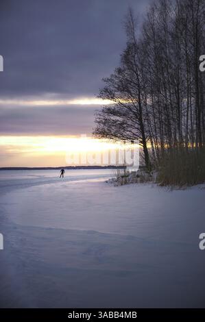 Sunset over the frozen lake Stock Photo