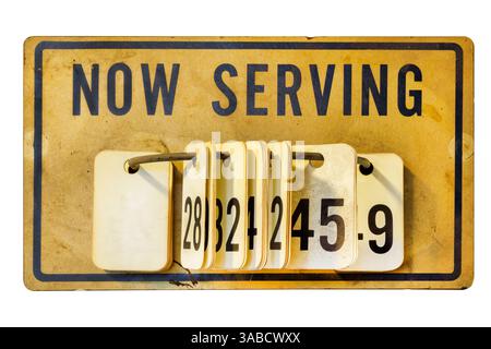 Antique Now Serving sign with numbers isolated on a white background Stock Photo