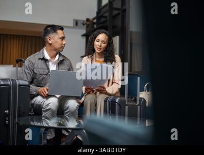 Business Professionals Collaborating in a Hotel Lobby with Luggage Stock Photo