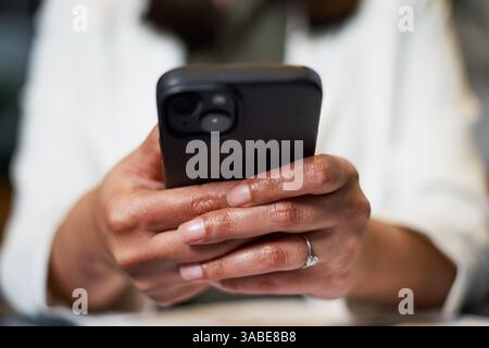 Close-Up of Hand Holding a Smartphone in Modern Technology Setting Stock Photo
