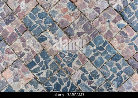 Street paved with cobblestones, view from above. Beautiful background of paving slabs. Stock Photo