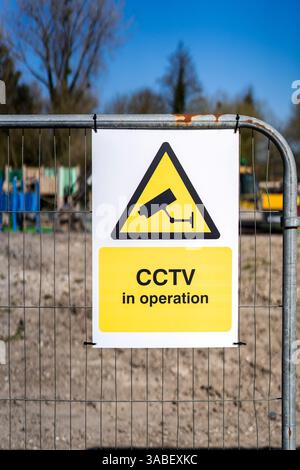 CCTV in operation sign on metal fence Stock Photo