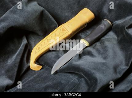 Traditional Marttiini Lapp Belt Knife And Leather Sheath on black velvet fabric Stock Photo