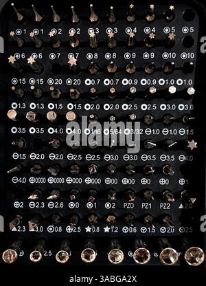 top view of A set of multi-size bits for screwdriver. A set of bits for repair Stock Photo
