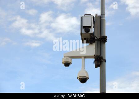 Surveillance cameras mounted on the pole with blue sky Stock Photo