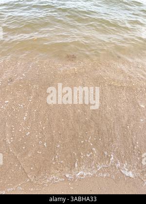 Soft wave of blue ocean on sandy beach. Background. Stock Photo