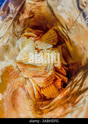 Top view close up photo image on heap of fried potato chips in a plastic bag, junk and unhealthy food Stock Photo