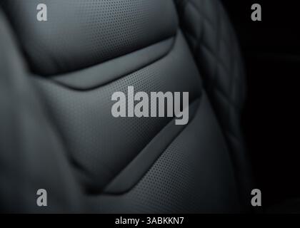 Car leather seat - close-up view. Black leather seat in modern car - selective focus. Stock Photo