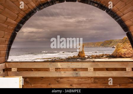 Cullen Bay Moray Coast Scotland the view of the bay and sea from the window inside the wooden sauna on the beach Stock Photo
