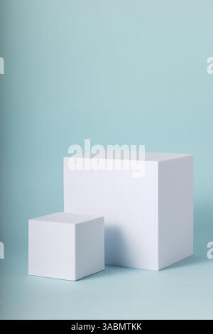 Showcase stands for online marketing. Mock up for your products with white cubes on blue backdrop. Stock Photo