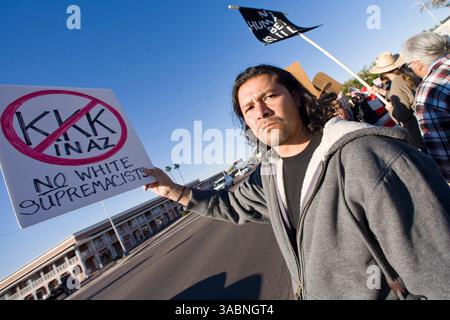 Dec 15, 2007 - Phoenix, Arizona, USA - A pro-immigrant protestor holds up a sign during an immigration rally on an intersection in central Phoenix. The corner of 35th Street and Thomas Road in Phoenix has emerged as 'Ground Zero' in the immigration debate in Arizona. A furniture store at the intersection has hired off duty sheriff's deputies to arrest day laborers who used to gather near there for loitering. Pro immigrant groups have labored the move racist while anti-immigrant groups call it law abiding and patriotic. Every week, hundreds of people gather on opposite corners of the intersecti Stock Photo