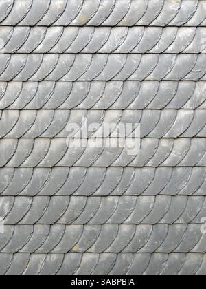 Gray slate shingles form a pattern on a facade, backgrounds Stock Photo