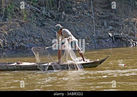 A fisherman pulls in his net in the Mekong Delta near Ben Tre, Vietnam ...