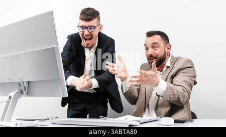 Two happy successful excited businessmen celebrating a successful stock trade, the rise of cryptocurrencies in the crypto stock market. Stock Photo